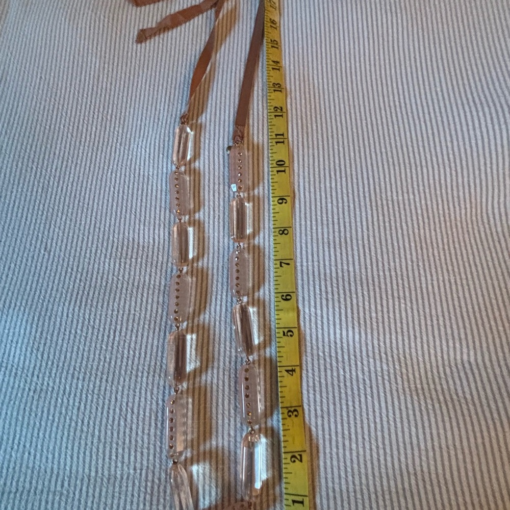 J. Crew,Clear pink hued with  Brown tie ribbon Necklace.